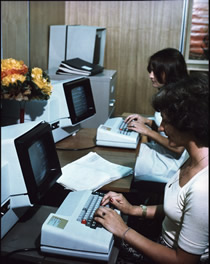 Library staff using computers to assist with the word processing and presentation of publications, 1983